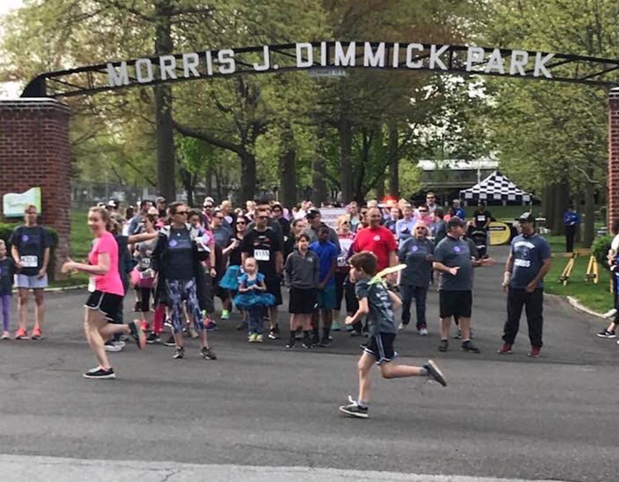 Special Events - People Smiling and Running down a Road in Morris J. Dimmick Park for the Sassy Massy Fun Run